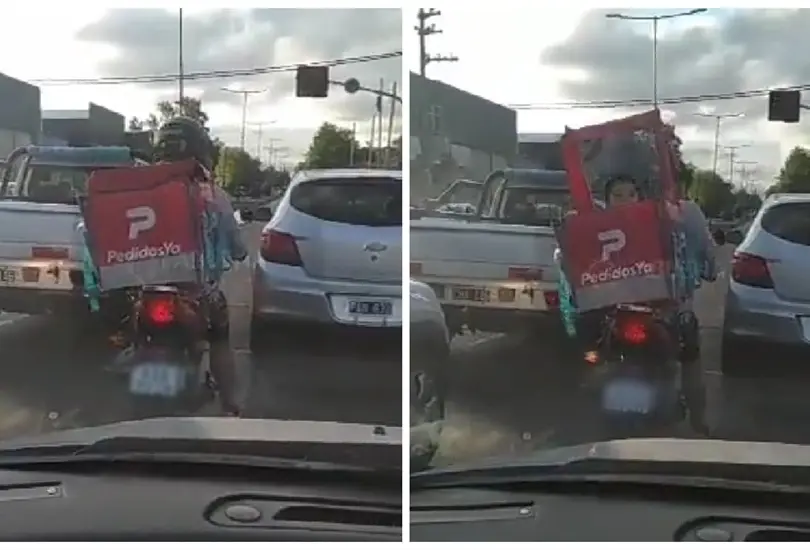 Captan a repartidor con su hijo en la mochila 