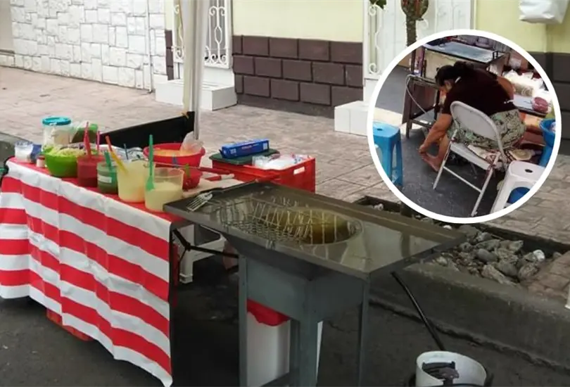 Vendedora se rasca los pies en su puesto de quesadillas Vendedora se rasca los pies en su puesto de quesadillas
