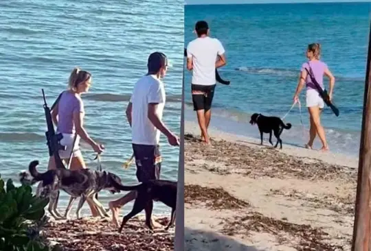 Captan a mujer extranjera caminando por la playa con un rifle. Captan a mujer extranjera caminando por la playa con un rifle.