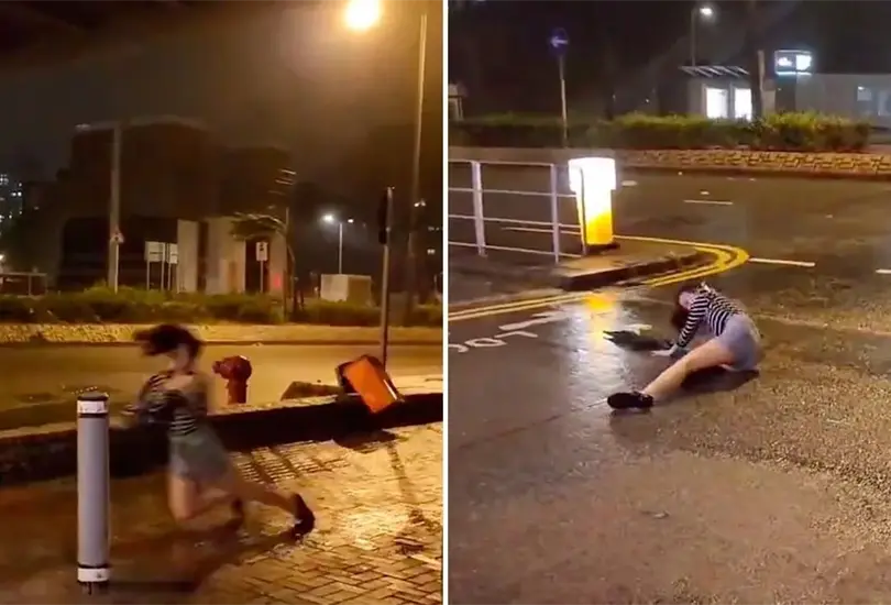 Vientos del tif&oacute;n Saola arrastran a una mujer en Hong Kong. 
