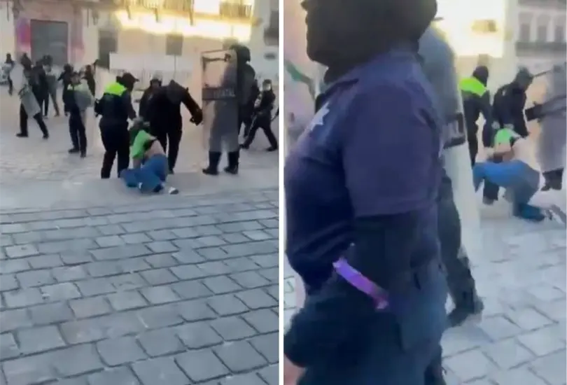 Polic&iacute;as arrastran a mujer por la calle en marcha del 8M. 