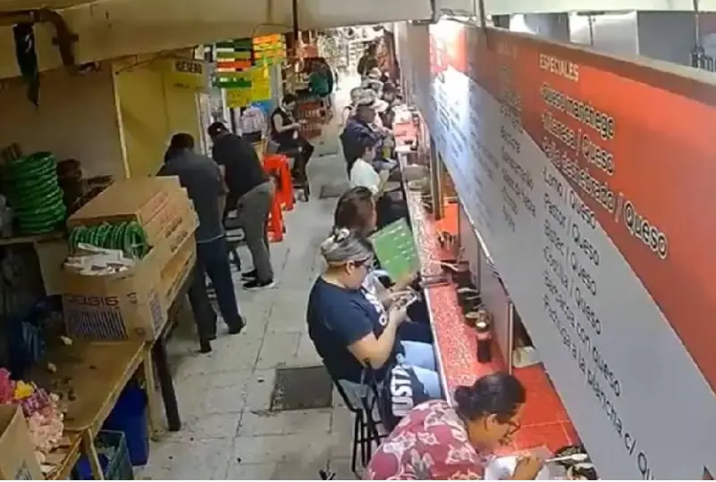 La mujer agarra su bolso para escapar, pero regresa inmediatamente a tomar su refresco de cola Captura de pantalla.