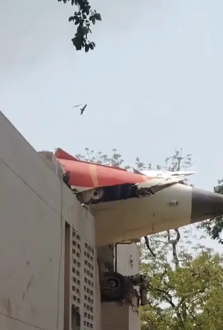 Bomberos y personal de rescate trabajan en los escombros del avión y en un edificio cercano que resultó dañado por el impacto. Captura de pantalla.