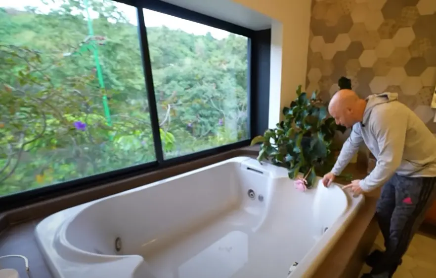 El baño de la recámara principal tiene jacuzzi con ventana hacia el bosque.